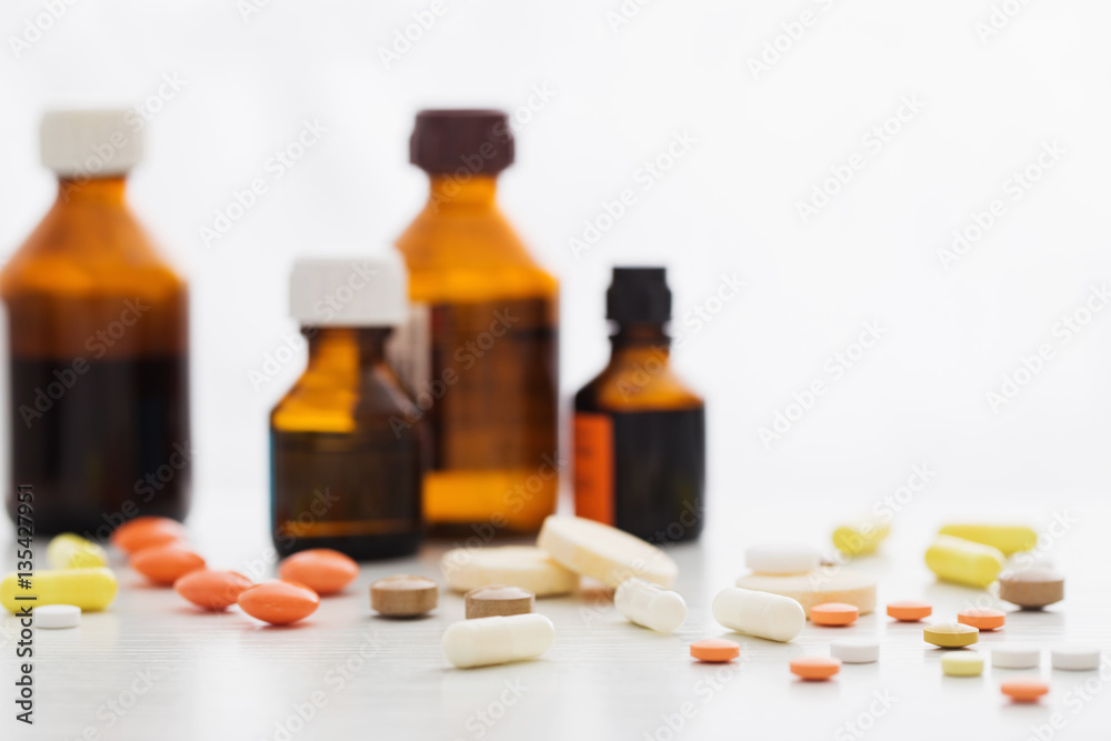 Composition of medicine bottles and pills on white background Composition of medicine bottles and pills on white background
