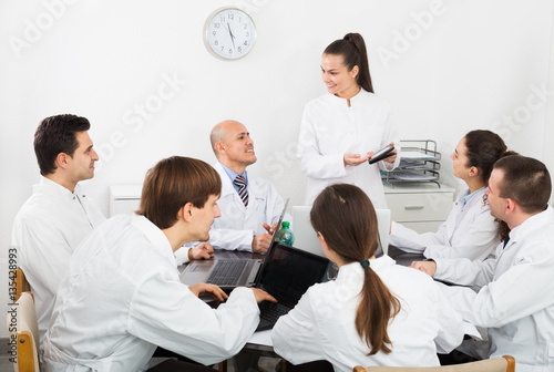 Interns and professor at hospital meeting