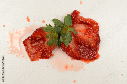 Juicy strawberries crushed on bench