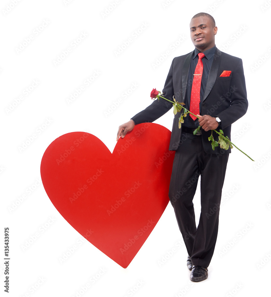 Smiling african man holding red rose in hand. Smiling african man holding red rose in hand.