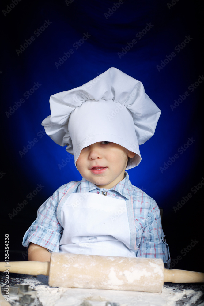 young funny cook with kitchenware young funny cook with kitchenware