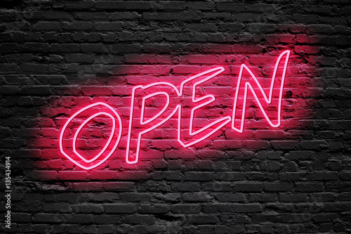 OPEN. fluorescent Neon tube Sign on dark brick wall. Front view. Can be used for online banner ads or background. night moment.
