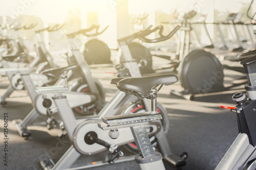 Modern gym interior with equipment, fitness exercise bikes © Prostock-studio