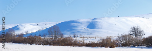 Panoramic view of snow-covered hills in central Russia. Winter s