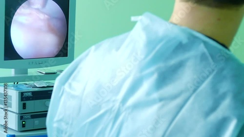 Doctor looking in endoscope monitor during surgery