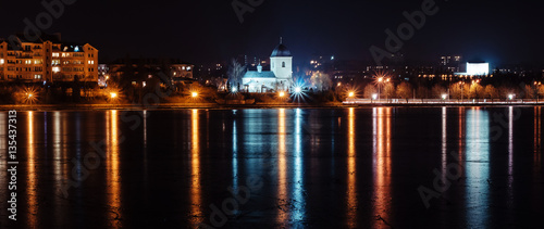 Panorama of night city lights and reflections on lake at Ternopi photo
