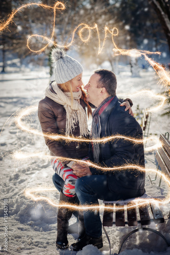 smiley lovers couple with sparklers happiness at winter time