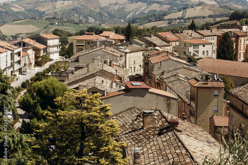 Fototapeta premium Look from above at red roofs of old Italian town
