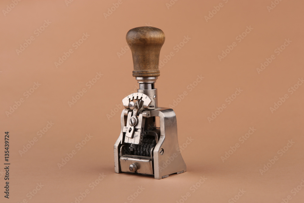 Vintage date stamp. Industrial office stamp. Old numbering machine isolated  on brown. Stock Photo | Adobe Stock