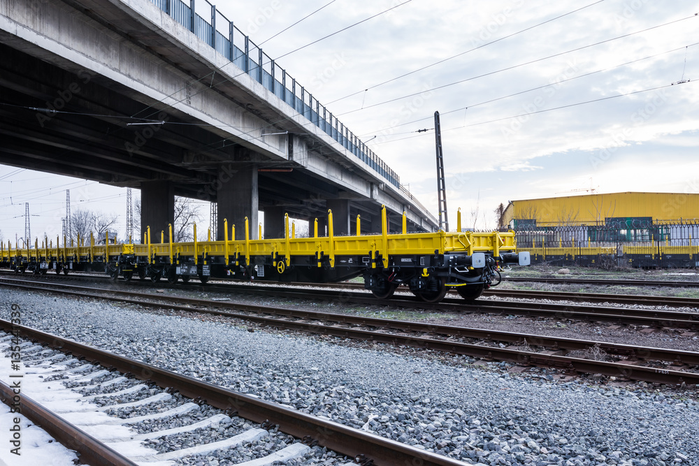 Burgas, Bulgaria - January 27, 2017 - Freight cargo train - yellow black New 4-axled flat cars wagons Type:Res Model:072-2- Transvagon AD