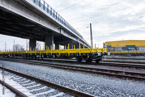 Burgas, Bulgaria - January 27, 2017 - Freight cargo train - yellow black New 4-axled flat cars wagons Type:Res Model:072-2- Transvagon AD