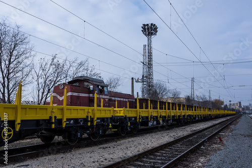 Burgas, Bulgaria - January 27, 2017 - Freight cargo train - yellow black New 4-axled flat cars wagons Type:Res Model:072-2- Transvagon AD