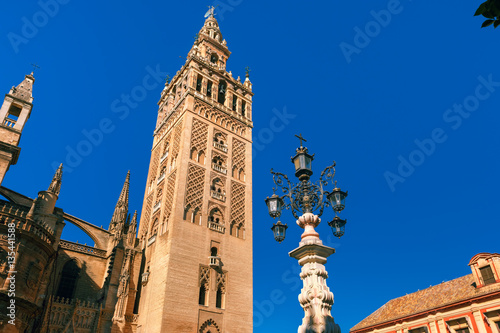 Famous Bell Tower named Giralda in landmark catholic Cathedral Saint Mary of the See in the morning, Seville, Andalusia, Spain