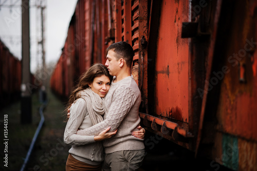 Young couple wearing on tied warm sweaters hugging in love at ra © AS Photo Family