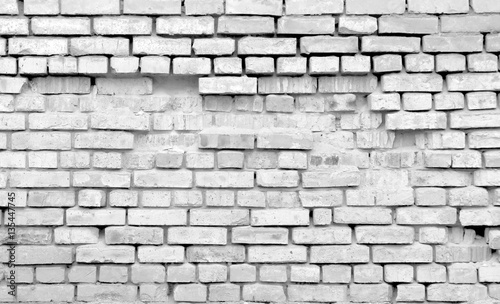 Old destroyed brick wall. Monochrome background