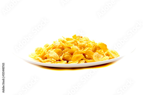 Falling flakes breakfast cereal isolated on white background. Healthy breakfast.