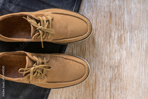 Close up vintage leather shoes man accessory. Men's casual outfits with accessories on rustic wood background. photo