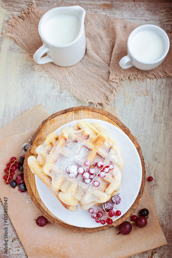 Homemade waffles with berries in a blue wooden tray Homemade waffles with berries in a blue wooden tray