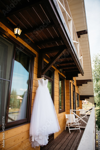 White wedding dress hanging on the balcony