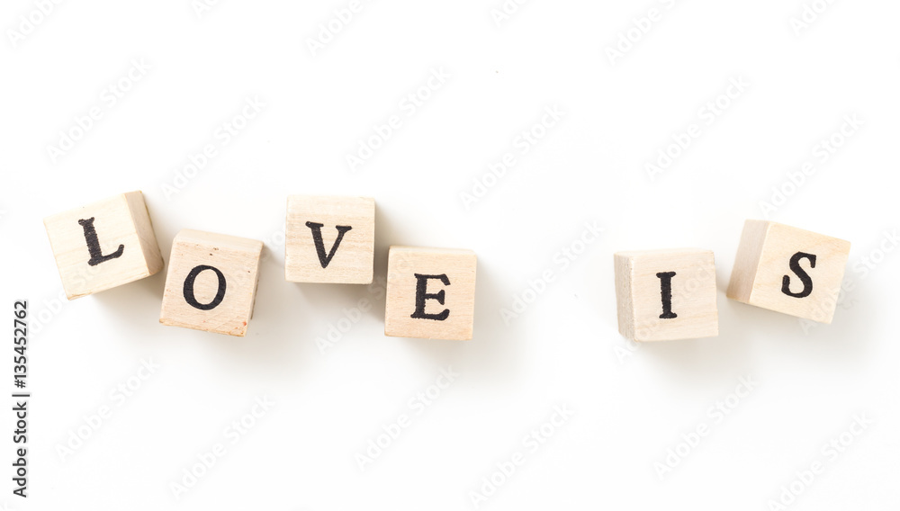 Wooden cubes with words Love Is, on white background. Wooden cubes with words Love Is, on white background.