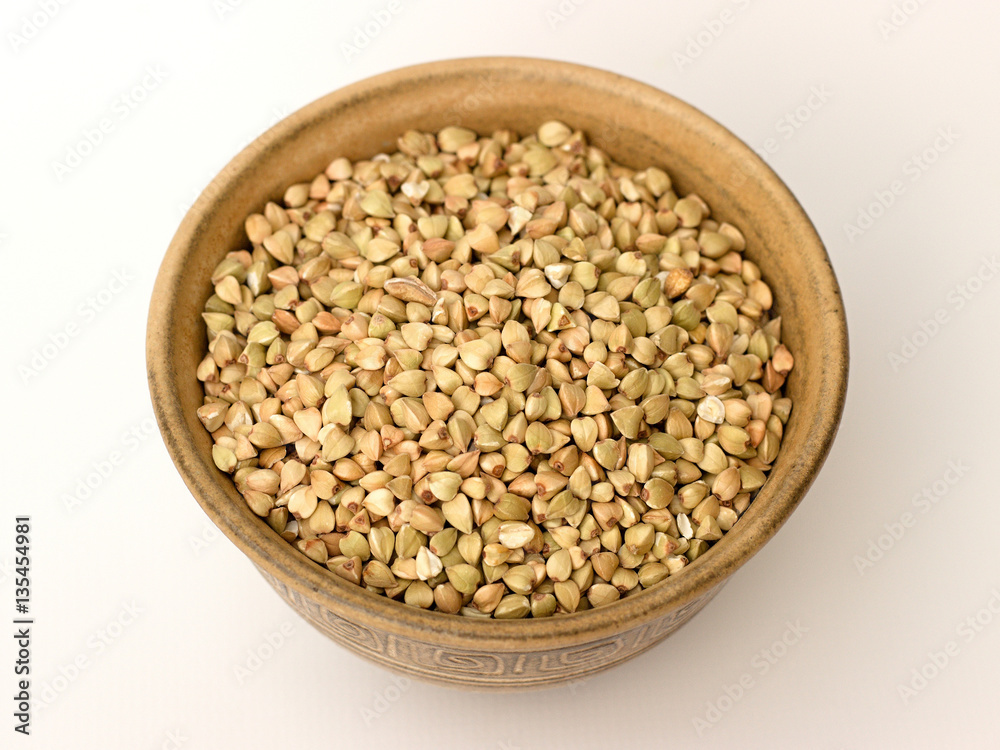 Buckwheat in a bowl on a white background Buckwheat in a bowl on a white background