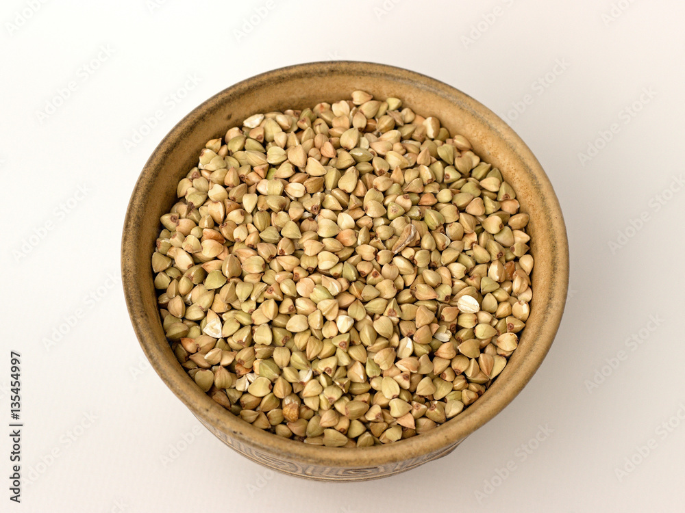 Buckwheat in a bowl on a white background Buckwheat in a bowl on a white background