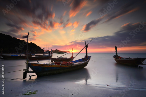 Silhouette Fisherman boat and sunset .