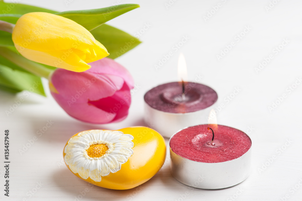 Lit candles and yellow heart
