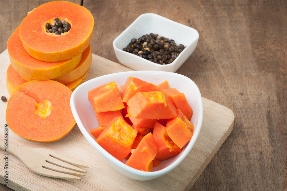 kitchen table with slice fresh papaya on cutting board, papaya s kitchen table with slice fresh papaya on cutting board, papaya s