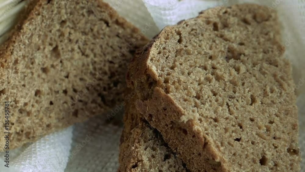 Close-up of basket with three pieces of bread in it on restaurant wooden table. Remains of lunch. Detailed shot. Close-up of basket with three pieces of bread in it on restaurant wooden table. Remains of lunch. Detailed shot.