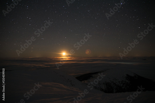 moon above  clouds in  Mountains, cosmic space