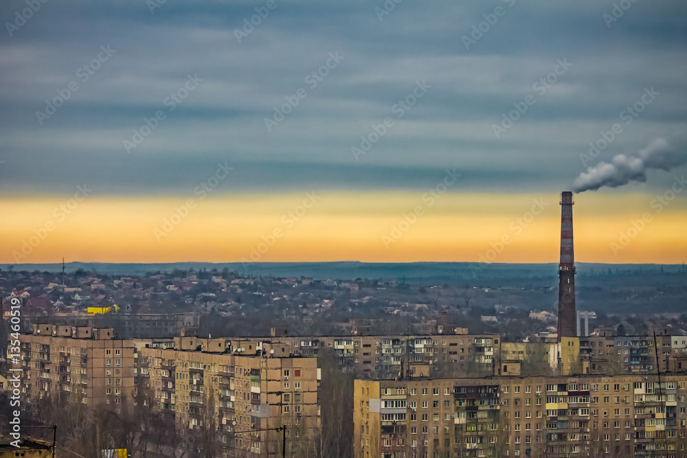 Obraz premium apartment buildings district and factory background, air pollution