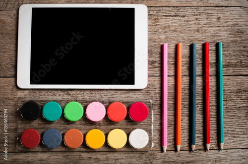 Designers tools ready to work from home laid out on a wooden textured background photo