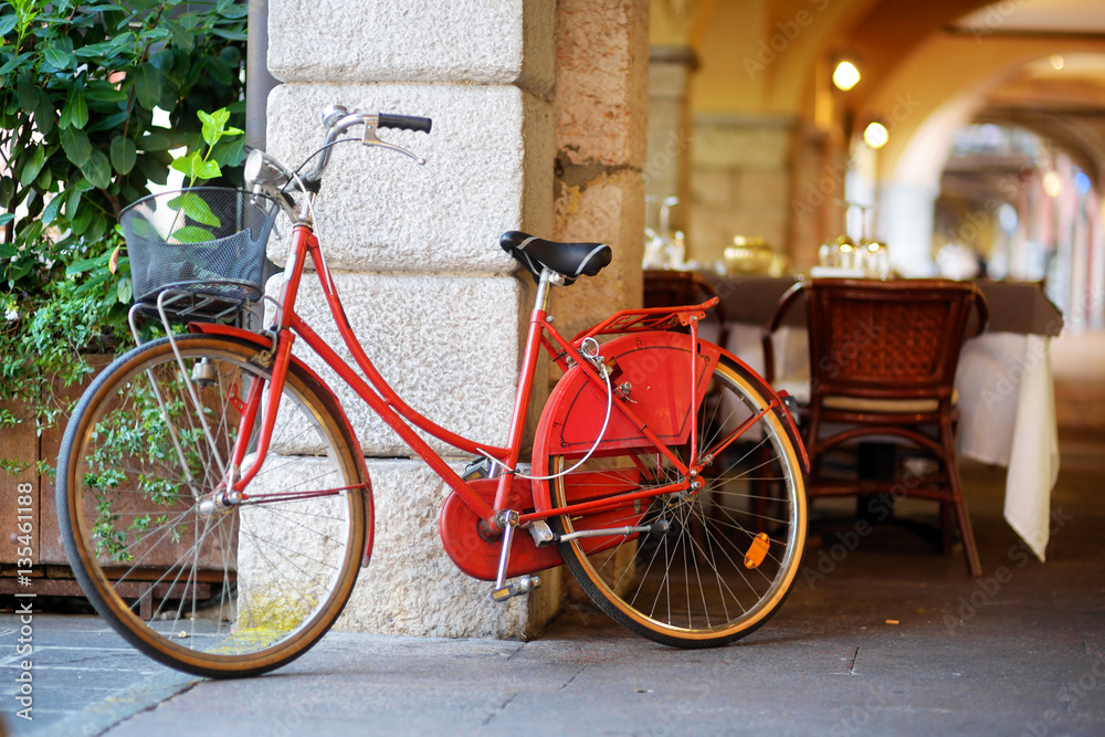 Funky red bike parked on a street in Desenzano del Garda town