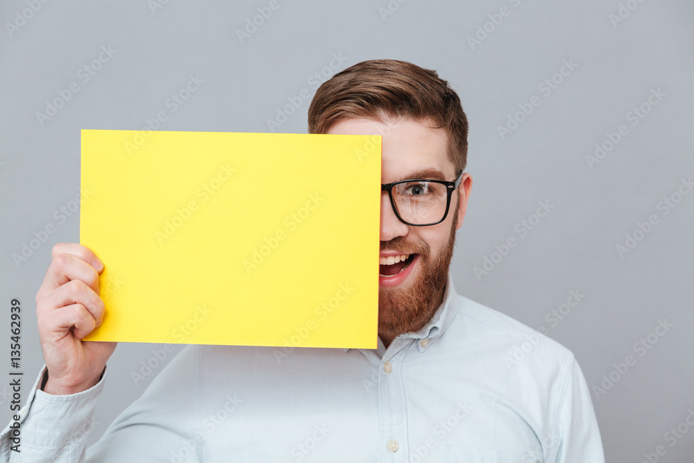 Happy young bearded businessman holding copyspace blank Happy young bearded businessman holding copyspace blank