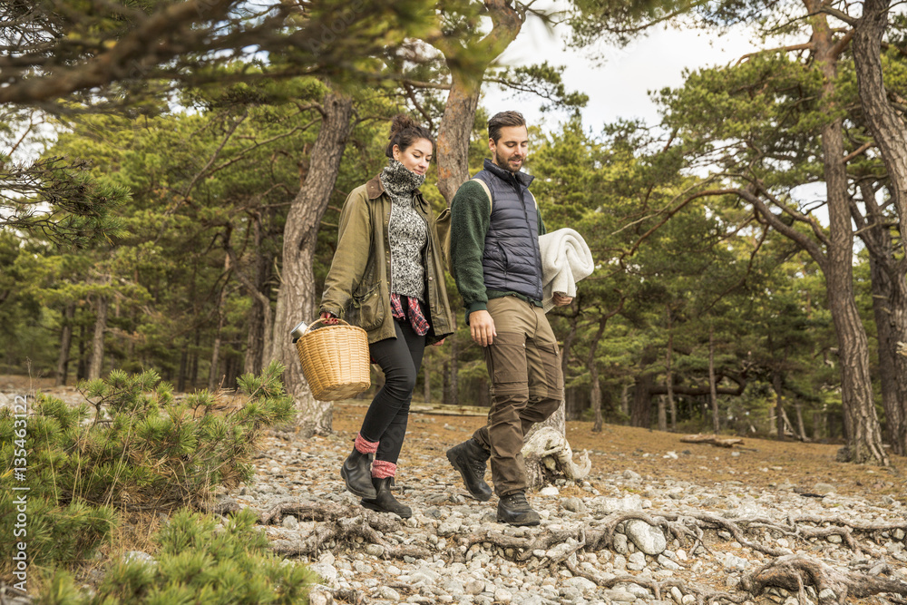 Couple in forest with picnic basket and blanket Couple in forest with picnic basket and blanket