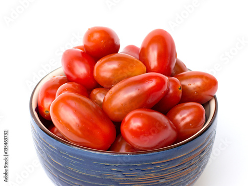 cherry tomatoes in a bowl on a white background