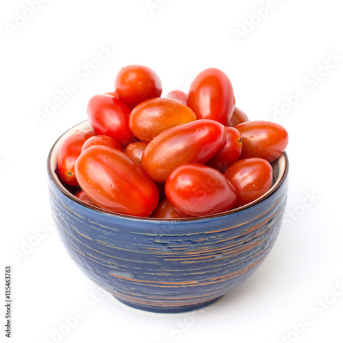 cherry tomatoes in a bowl on a white background