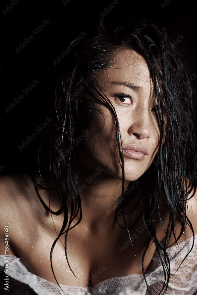 Portrait of a young model with wet hair and raindrops on her skin Portrait of a young model with wet hair and raindrops on her skin