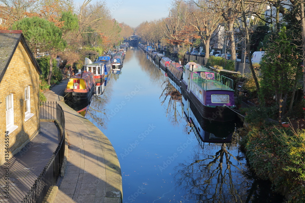LONDON, UK: Reflections in Little Venice with colorful barges along canals
