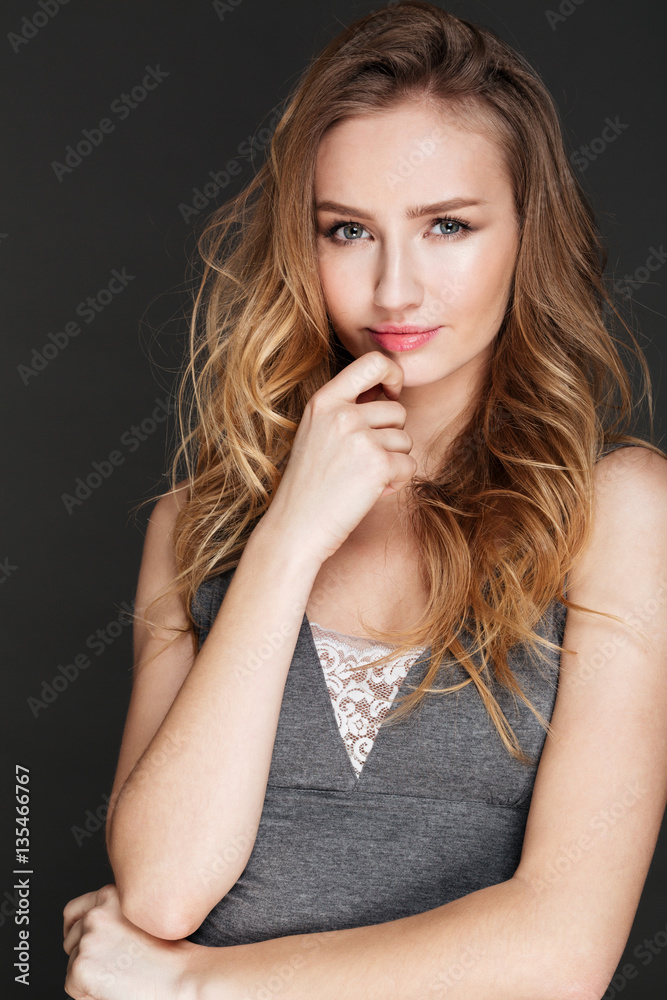 Pretty woman posing over dark background Pretty woman posing over dark background