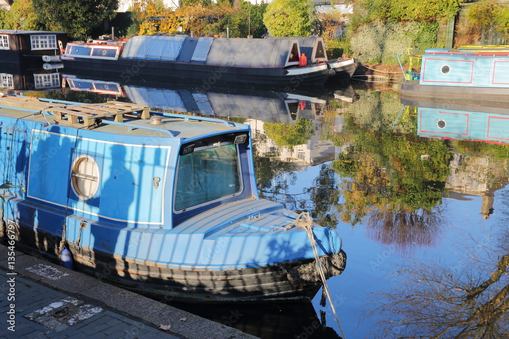 Fototapeta premium LONDON, UK: Reflections in Little Venice with colorful barges along canals