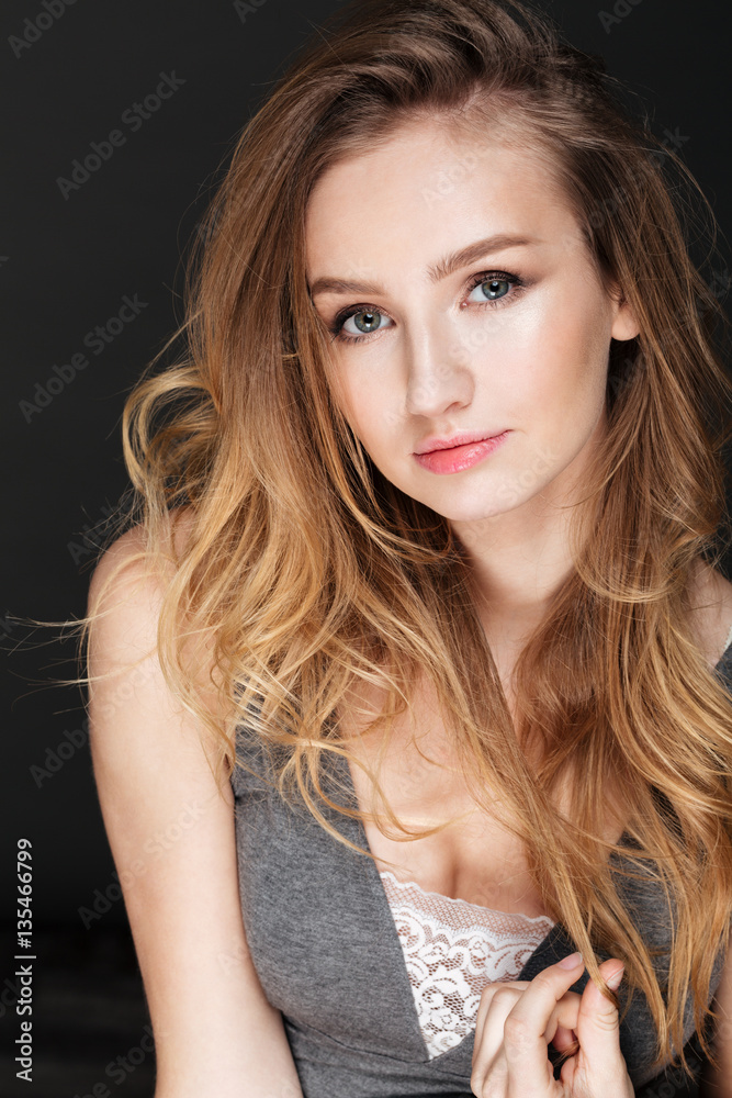 Fototapeta premium Beautiful lady posing over dark background