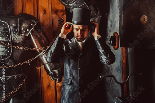 Slika na platnu Side portrait of Victorian gentleman adjusting his top hat.