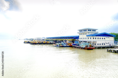 JOHOR, MALAYSIA - JANUARY 30, 2017: Fishing boats anchored at the jetty during the monsoon season at Endau, Johor, Malaysia. Endau is one of the most important fisheries in Johor. photo