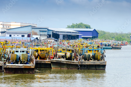 JOHOR, MALAYSIA - JANUARY 30, 2017: Fishing boats anchored at the jetty during the monsoon season at Endau, Johor, Malaysia. Endau is one of the most important fisheries in Johor. photo