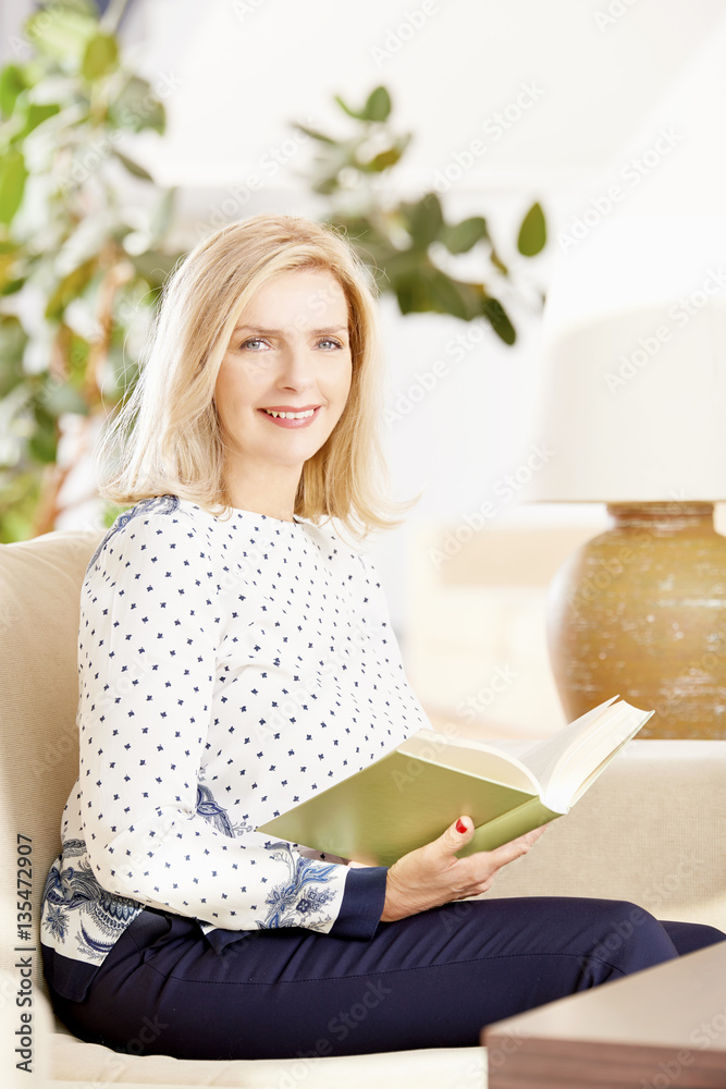 Relaxing with a good book Senior woman reading at home. Relaxing with a good book Senior woman reading at home.