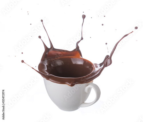 Hot chocolate splash in white cup isolated on white background