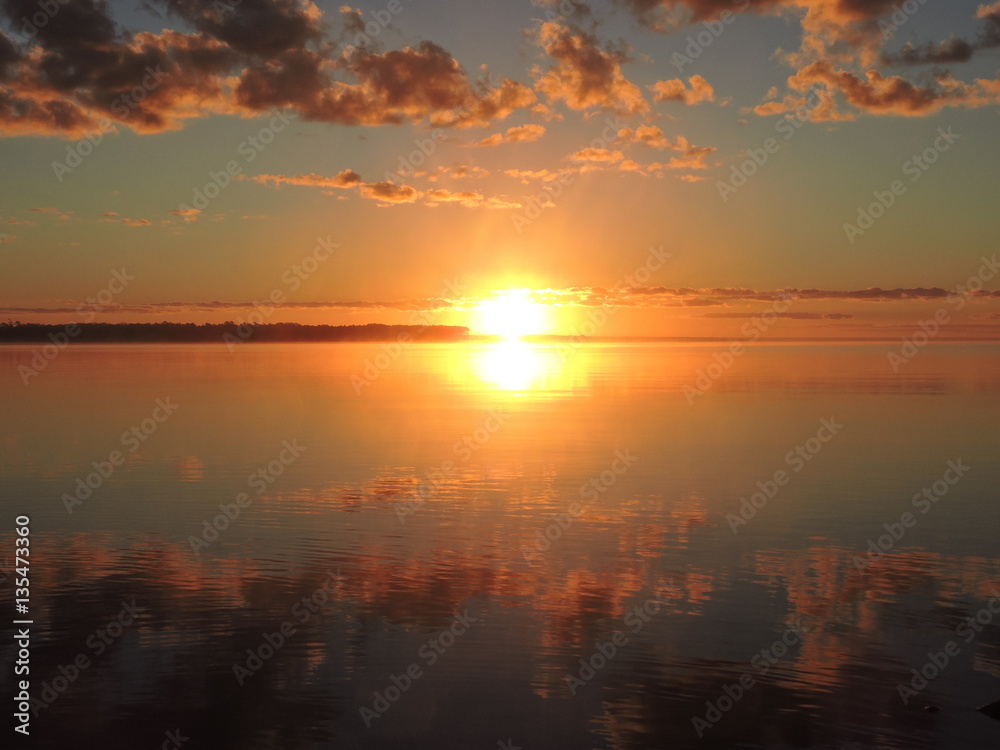 reflection of a sunrise over water