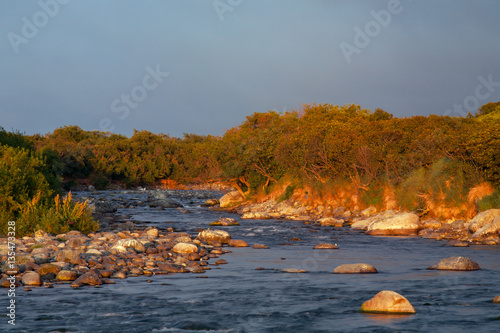 Rocky river banks with low-lit by the sun. Peninsula Kony. Magadan Region. Russia. photo